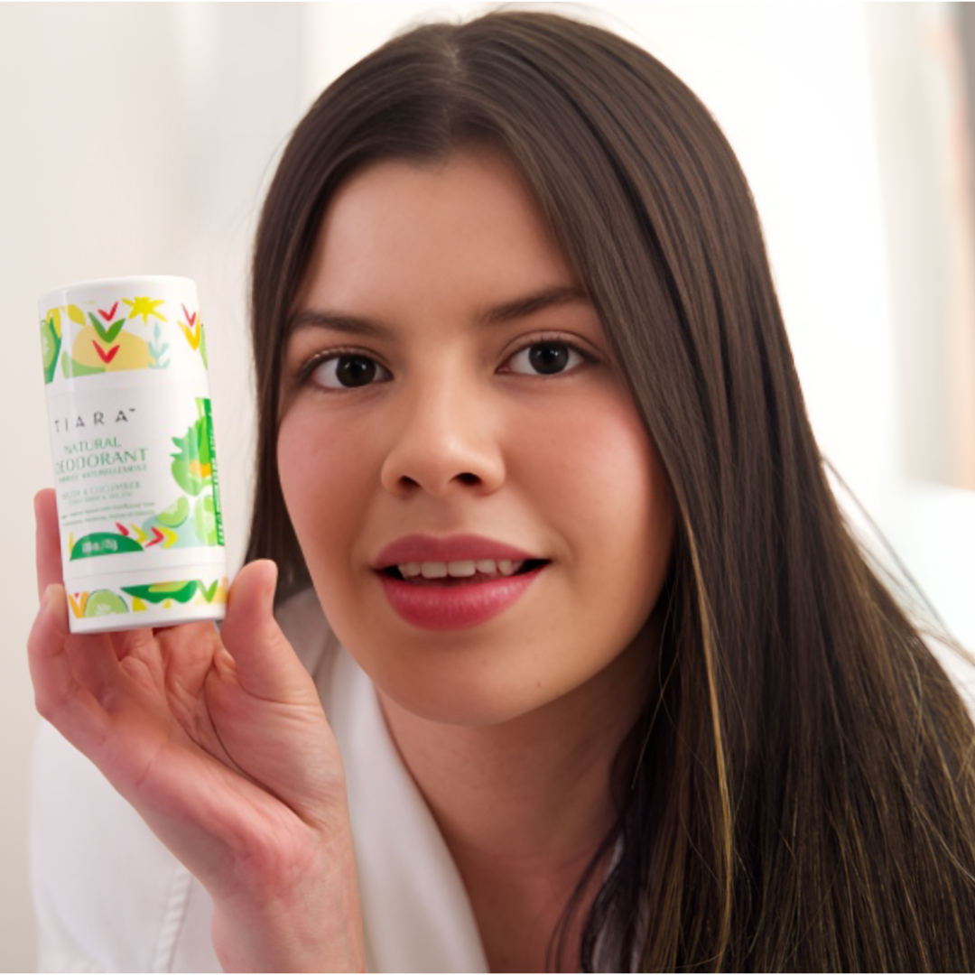 A WOMAN HOLDING THE TIARA NATURAL DEODORANT MELON AND CUCUMBER